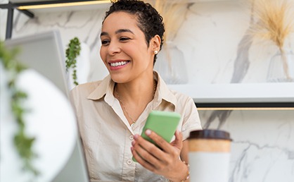 smiling woman holding phone