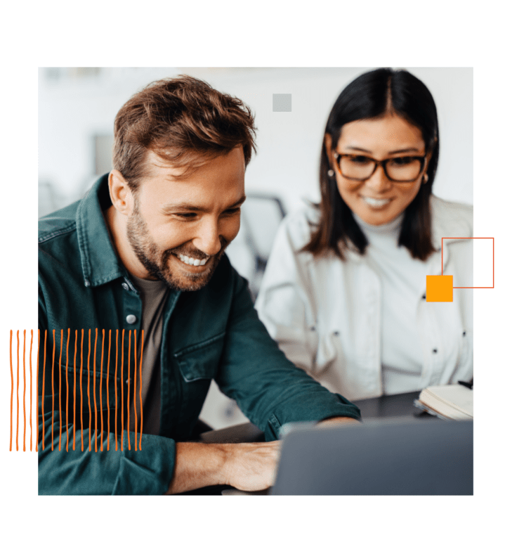 happy man and woman looking at laptop