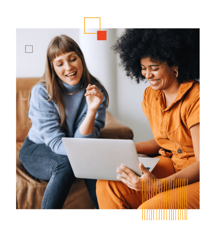 smiling woman holding laptop sitting next to person