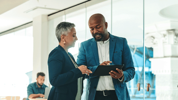 two professionals looking at a clipboard