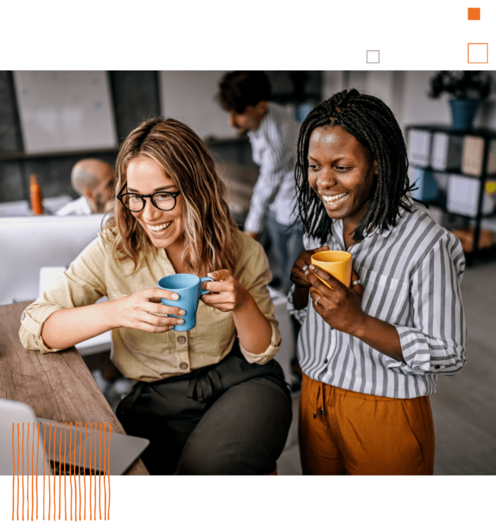 two women sharing coffee and smiling