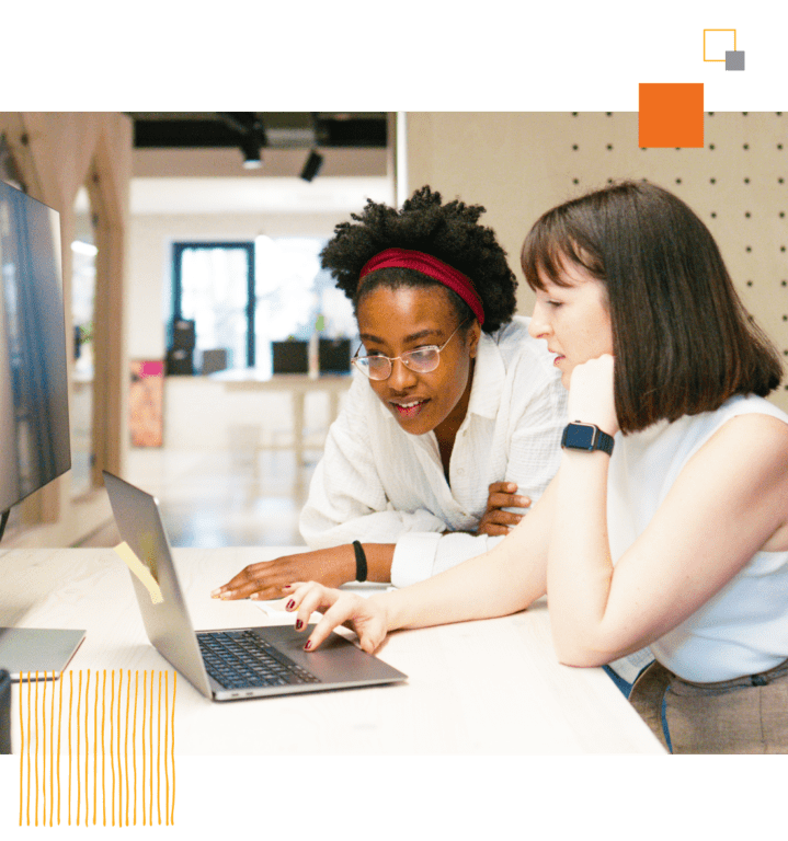 two workers using laptop together