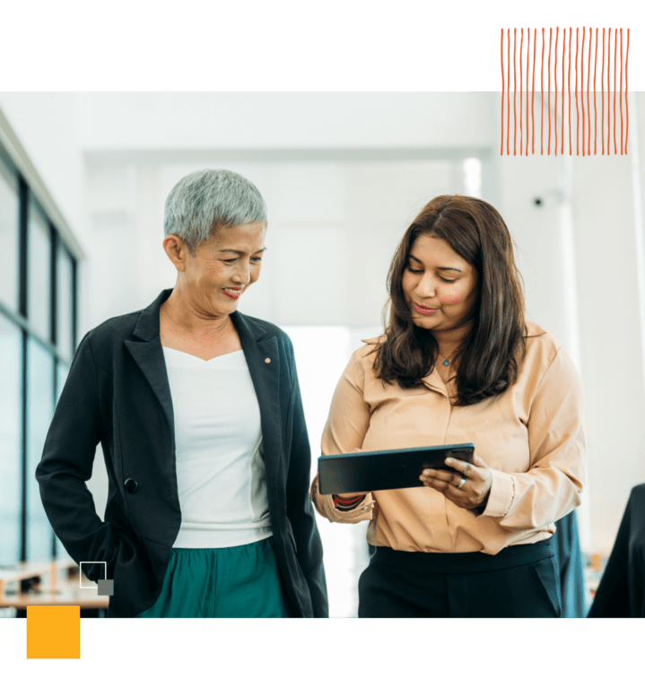 two workers looking at tablet together