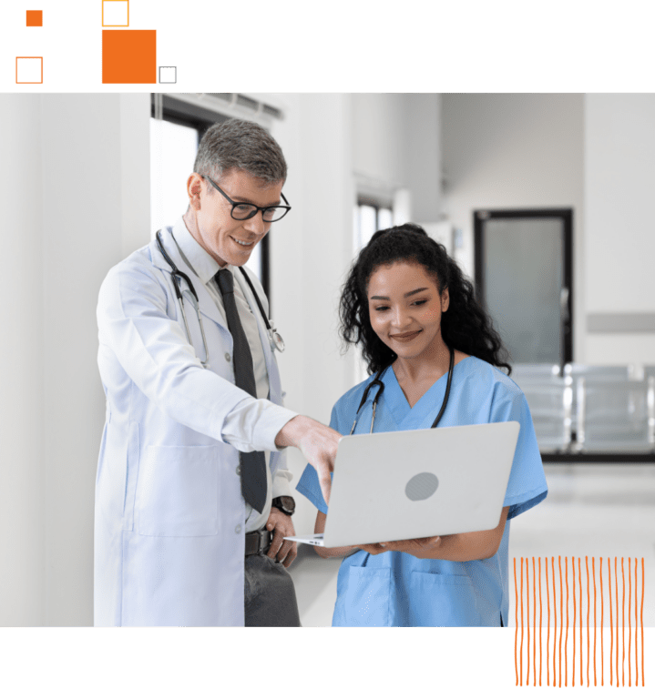 two medical professionals looking at laptop together