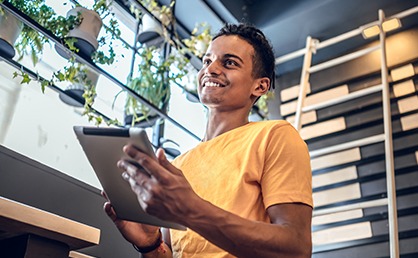 Smiling man holding a tablet