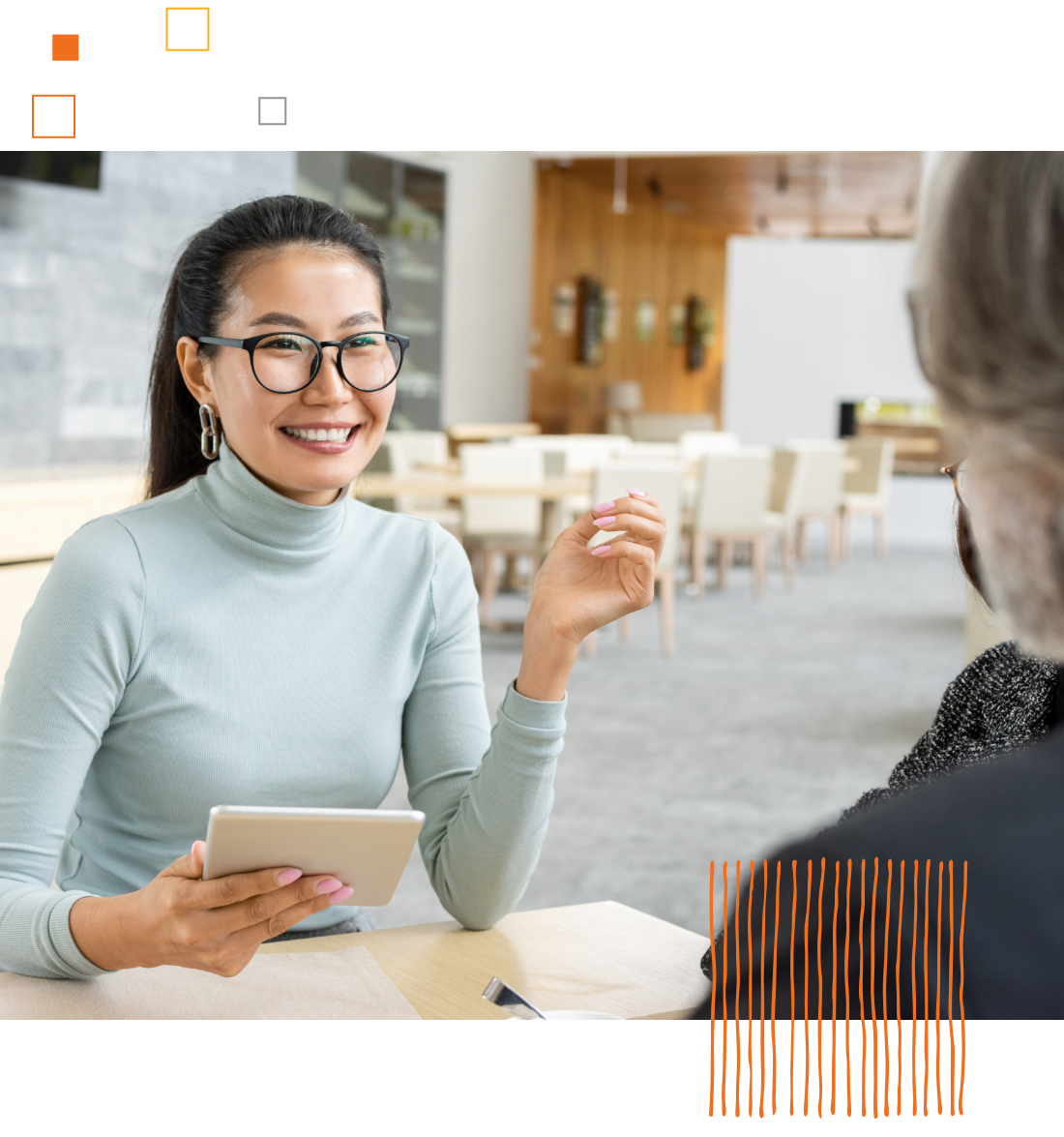 smiling woman looking across table at another person