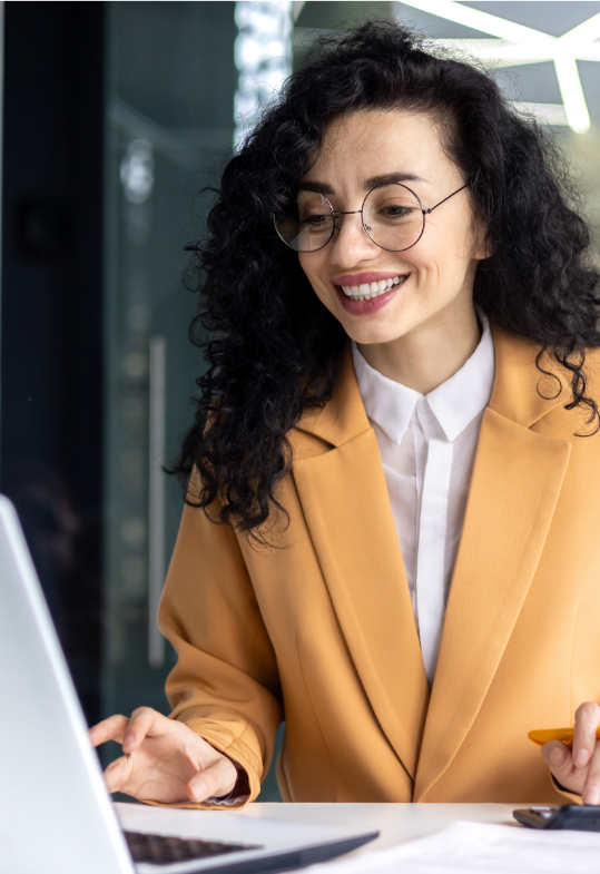 Woman smiling as she touches computer with hand