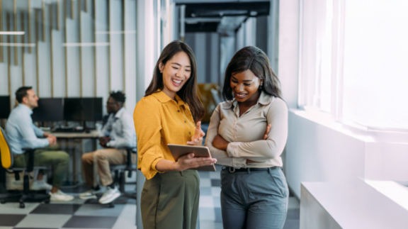 two women analyzing employee retention statistics
