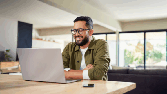 employee smiling while reading about no tax on overtime bill information on a computer