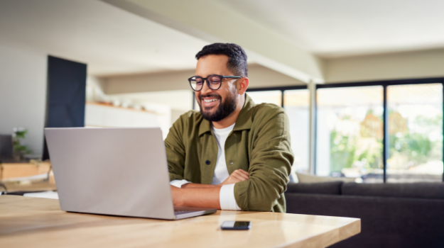 employee smiling while reading about no tax on overtime bill information on a computer