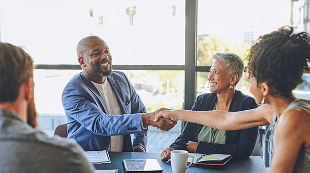 HR leaders smiling after using an onboarding email template