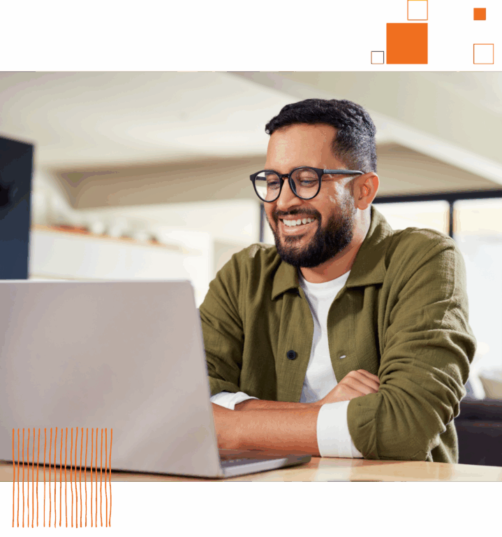 an employee smiling at his computer after accomplishing a Paycor Pro Certificaiton