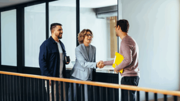 recruiter at an enterprise business shaking hands with new employee