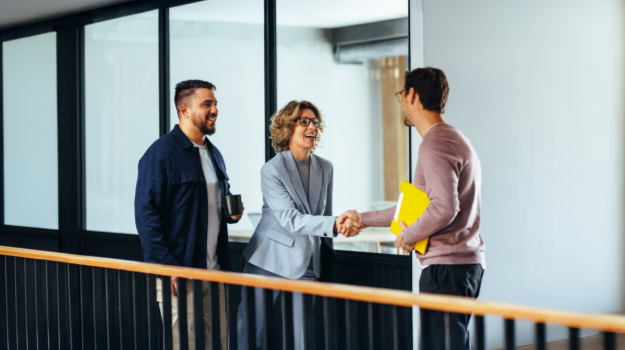 recruiter at an enterprise business shaking hands with new employee