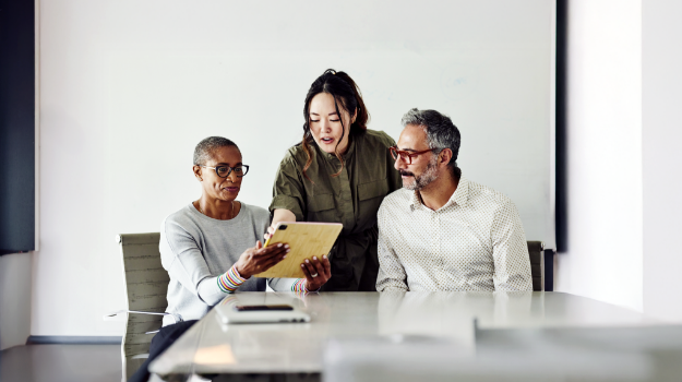 Employees evaluating the best hcm software companies