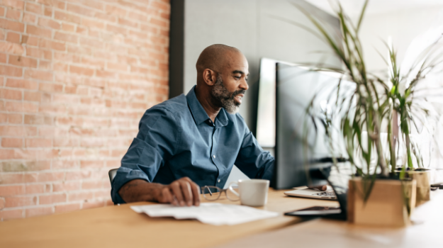 employer researching for the best hr compliance software companies on a desktop computer