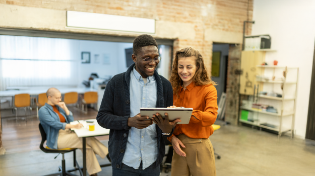 two HR professionals analyzing employee engagement statistics