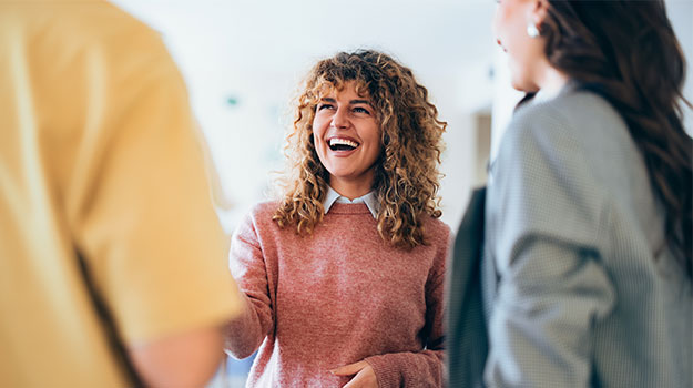 employee shaking hands with employer and smiling after being recruited through an applicant tracking system