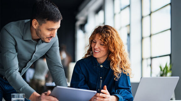 HR professionals researching strategic workforce planning effectively on a computer