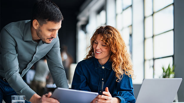 HR professionals researching strategic workforce planning effectively on a computer
