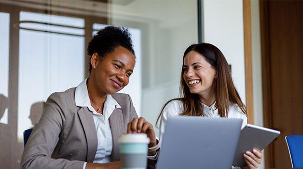 HR professionals looking at laptop
