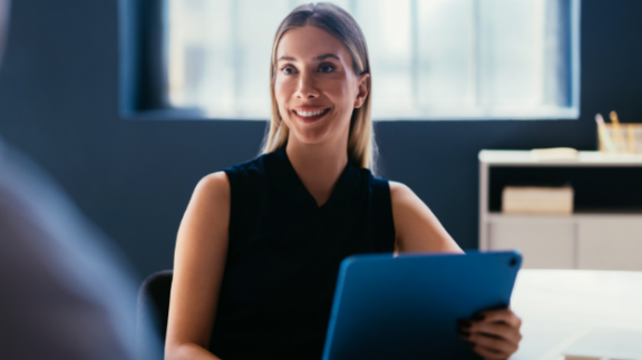 Woman presenting how AI can help with employee performance and review metrics.